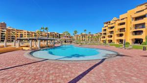 a swimming pool in the middle of a courtyard with apartment buildings at Ground Floor 2BR Beachfront - Steps to Pool - Princesa E104 - BeachBumCondos in Puerto Peñasco +37 photos