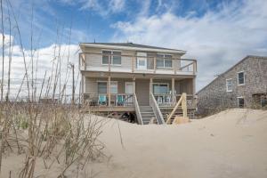 a house sitting on top of the sand at 5061 - Good Night Irene in Kill Devil Hills