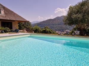 a swimming pool with a view of a mountain at Omah Jawa in Lourdes