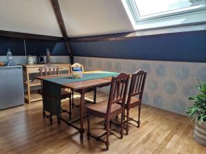 a kitchen with a table and chairs in a room at Omah Jawa in Lourdes