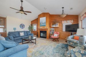a living room with blue furniture and a flat screen tv at 5437 - WeekAway in Nags Head +69 photos