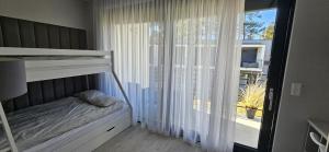 a bedroom with a bunk bed and a large window at Aprum Apartments 10C in Pobierowo +11 photos