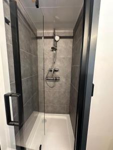 a shower with a glass door in a bathroom at Hausboot Nikolai Stralsund in Stralsund