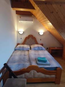 a bedroom with a large bed in a attic at Ferienhaus Magyar in Lovas +22 photos
