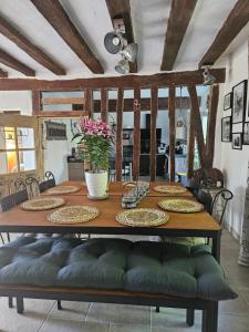 a dining room table with plates and flowers on it at Maison du bonheur in Seur