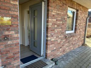 a brick house with a door on the side of it at Ferienhaus Tutsch Westblick in Wangels