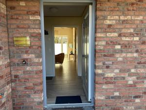 a brick wall with a door leading to a hallway at Ferienhaus Tutsch Westblick in Wangels