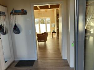 a hallway with a door leading into a room at Ferienhaus Tutsch Westblick in Wangels +29 photos