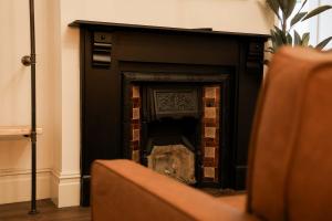 a fireplace in a living room with a black at Lovely Studio Flat on Bath Road - Flat 2 in Bristol