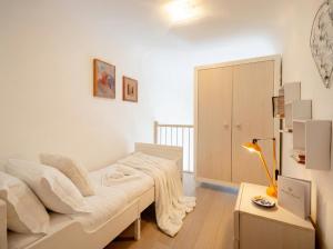 a bedroom with a bed and a table with a lamp at Lemon Tree House in Bari
