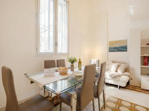 a dining room with a glass table and chairs at Lemon Tree House in Bari