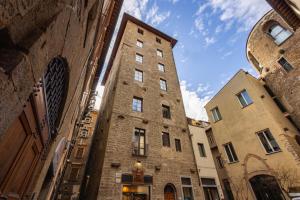 a tall brick building next to two other buildings at Donati Luxury Tower Suites in Florence