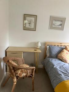 a bedroom with a bed and a desk and a chair at The Pudd in Aylesbury