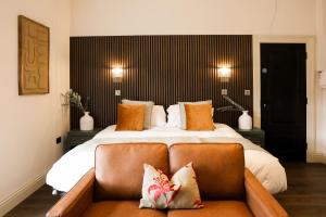 a bedroom with a large bed with a couch at Lovely Studio Flat on Bath Road - Flat 8 in Bristol