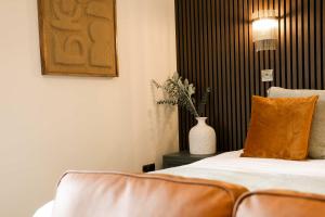 a hotel room with a bed and a vase of flowers at Lovely Studio Flat on Bath Road - Flat 8 in Bristol