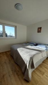 a bedroom with a large bed in a room at apartmán Monte Lope in Bystřice pod Lopeníkem