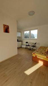 a bedroom with a bed and a table and chairs at apartmán Monte Lope in Bystřice pod Lopeníkem