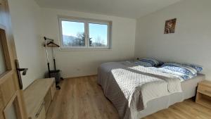 a bedroom with a bed and a window at apartmán Monte Lope in Bystřice pod Lopeníkem +16 photos