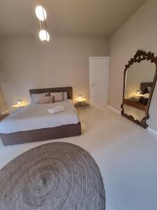 a bedroom with a bed and a large mirror at TM My Home in Novara