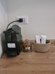 a black blender sitting on a wooden counter with baskets at TM My Home in Novara