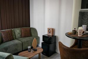 a living room with a couch and a table at Chocolat Paris, Cozy apartment in Levallois-Perret +11 photos