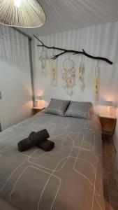 a bedroom with a large bed with a large at Maisonnette zen - Parking Gratuit in Avignon