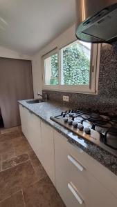 a kitchen with a stove and a counter top at Maisonnette zen - Parking Gratuit in Avignon