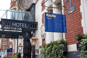 a blue hotel sign on the side of a building at Thistle London Holborn in London