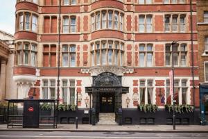 a large red brick building with a door at Thistle London Holborn in London