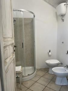 a bathroom with a shower and a toilet and a sink at Andrea E Valentina in S'archittu Cuglieri