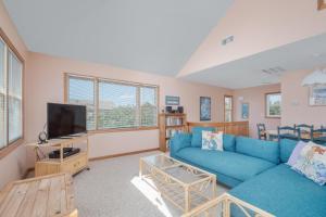 a living room with a blue couch and a tv at 7838 - Wilder View in Frisco