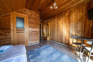 a bedroom with a bed in a wooden cabin at Chata u Szymczaka in Łopuszna
