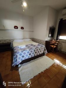 a bedroom with a bed with a polka dot blanket at Casa Tere in Benitachell