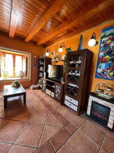 a large living room with a fireplace and a table at Casa del arco in Tarilonte