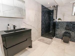 a bathroom with a black sink and a shower at 2 Manorhouse Farm in Rochdale +25 photos