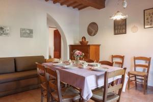 a dining room with a table and a couch at Agriturismo Le Pescine in Vada