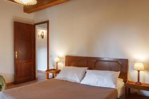 a bedroom with a bed with two lamps on two tables at Agriturismo Le Pescine in Vada +48 photos