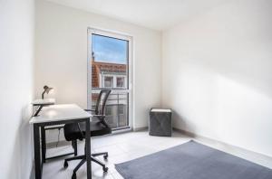 an office with a desk and a window at Dom Central Suite in Greifswald +6 photos