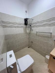 a bathroom with a toilet and a camera on the wall at Lethi Family Villa in Negombo +53 photos