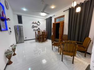 a living room with a dining room table and chairs at Lethi Family Villa in Negombo
