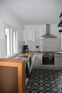 a kitchen with a sink and a stove top oven at La petite maison en Ardenne in Marche-en-Famenne +34 photos