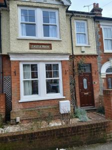 a brick house with a castle rock sign on it at Spacious 4 Bedroom House, Garden, Nr Ipswich Town Centre with hot tub in Ipswich
