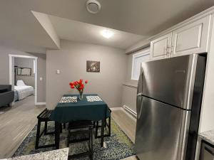 a kitchen with a table and a refrigerator at Federal Palace in Saskatoon
