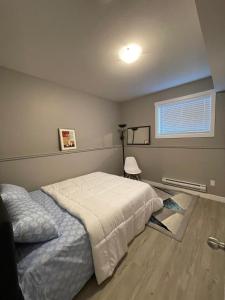 a bedroom with a bed and a window at Federal Palace in Saskatoon