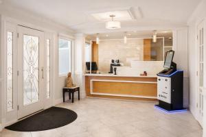a large bathroom with a tub and a sink at Destin Inn & Suites in Destin