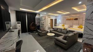 a living room with a couch and a bed at Dephantom Continental Hotel in Lagos