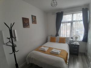 a bedroom with a bed with two towels on it at The Broadway Rooms in Leicester
