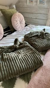 a bed with two blankets and two stuffed animals on it at The TreeHouse Hideaway in Shrewsbury