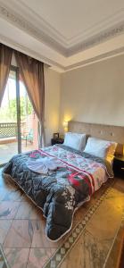 a bedroom with a large bed in a room at Chic Palm Grove Apartment Pool View in Marrakesh +27 photos
