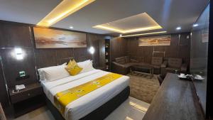 a hotel room with a bed and a living room at Dephantom Continental Hotel in Lagos